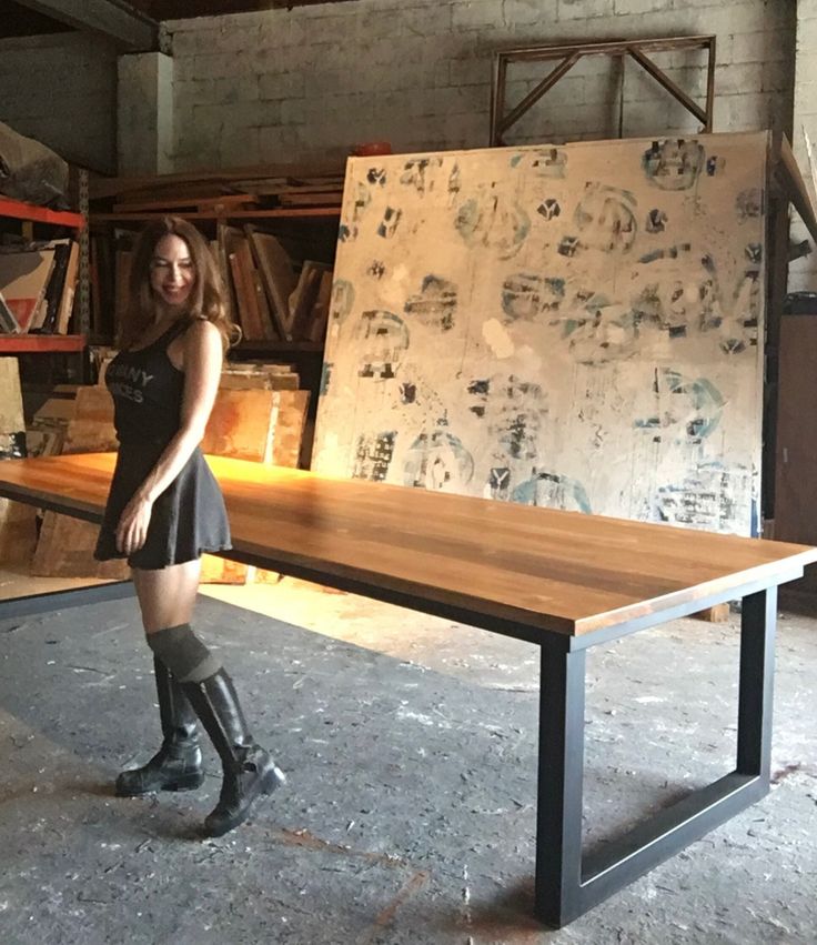 a woman standing next to a table in a room