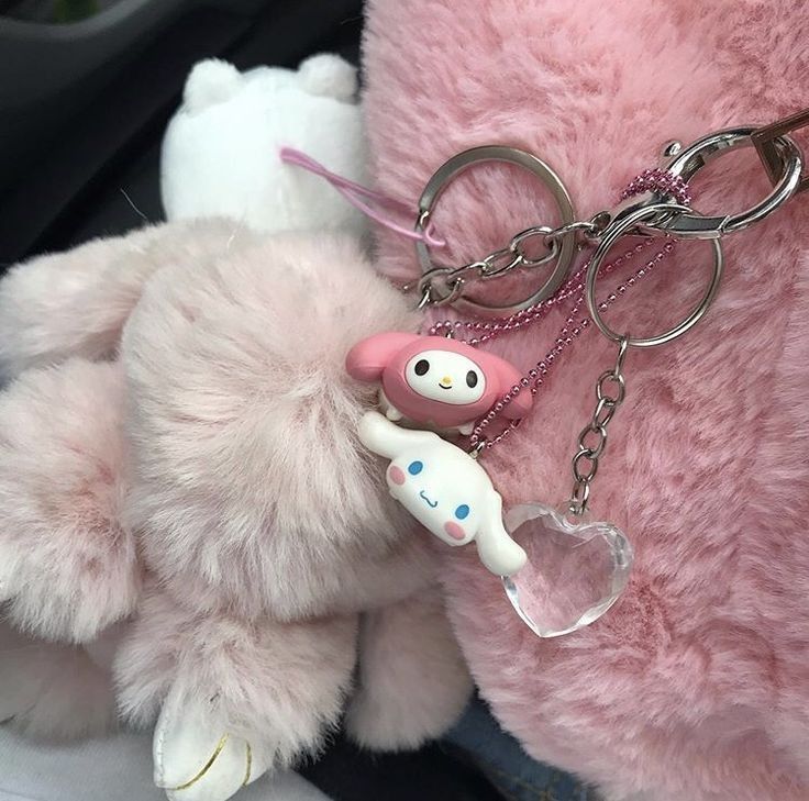 a pink stuffed animal with a keychain attached to it's back end