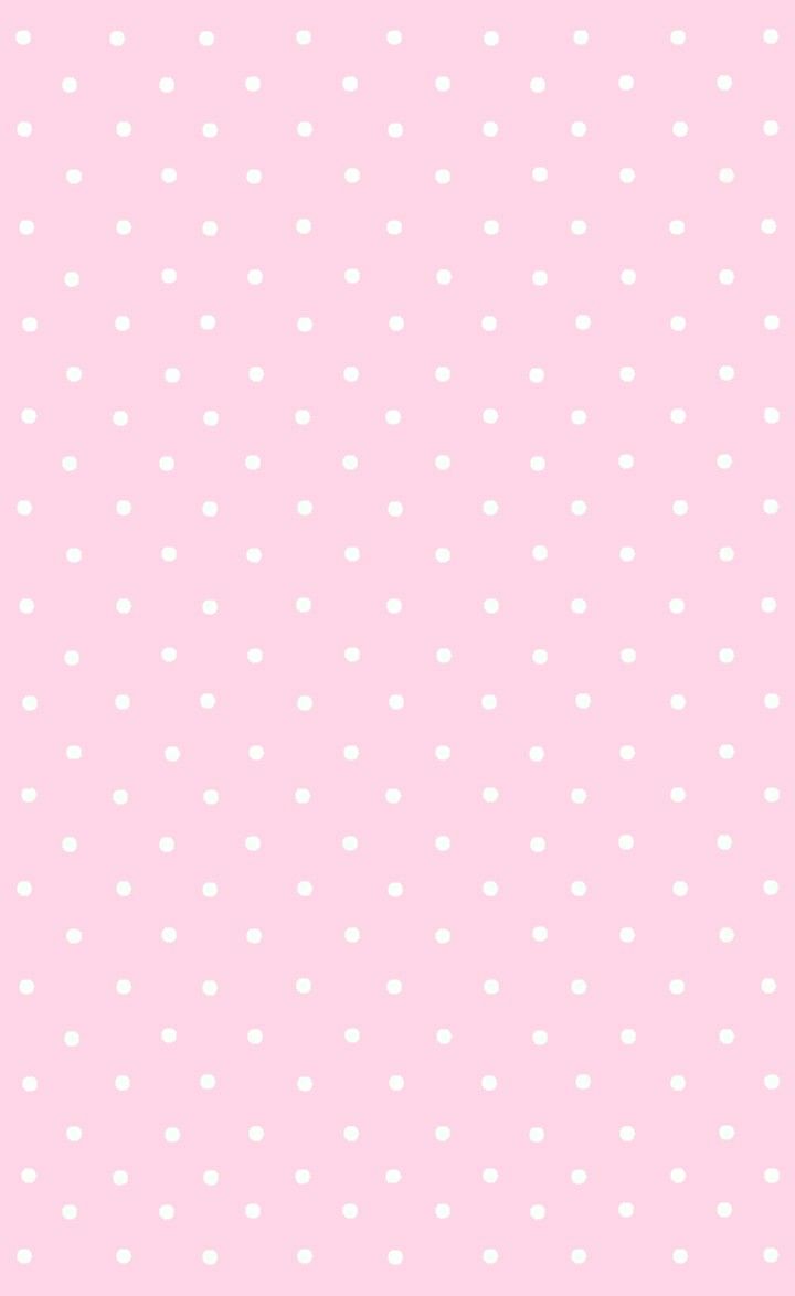 a pink background with white polka dots