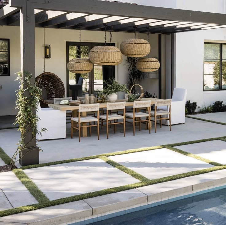 an outdoor dining area next to a swimming pool