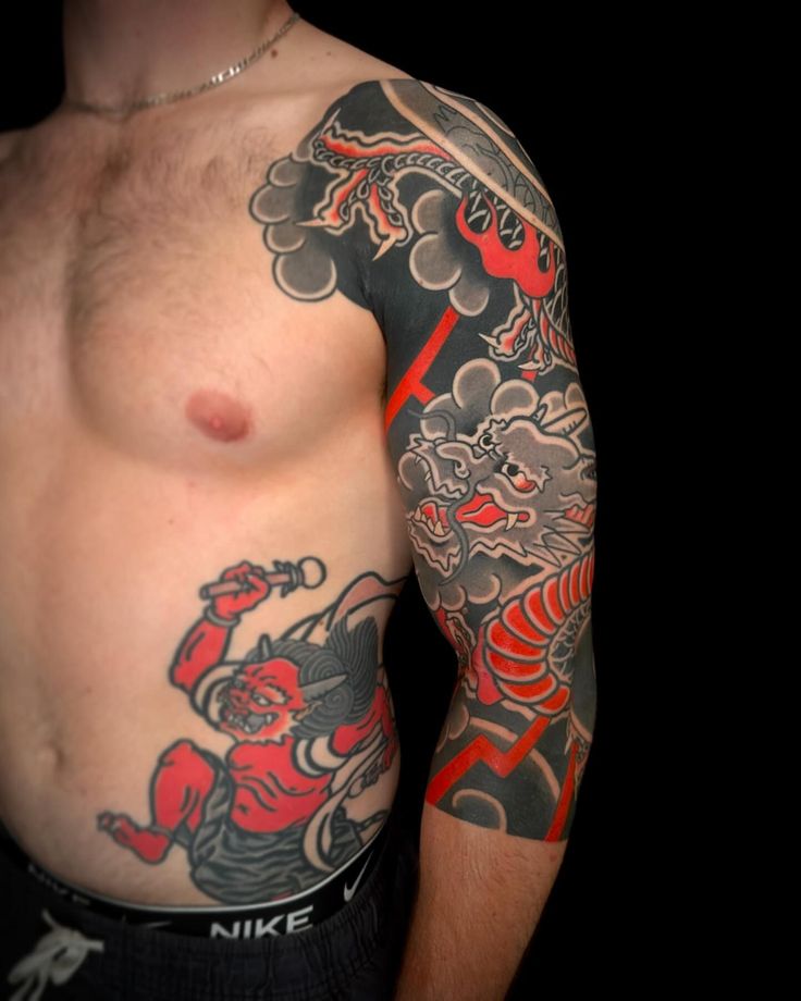 a man with tattoos on his arm and chest