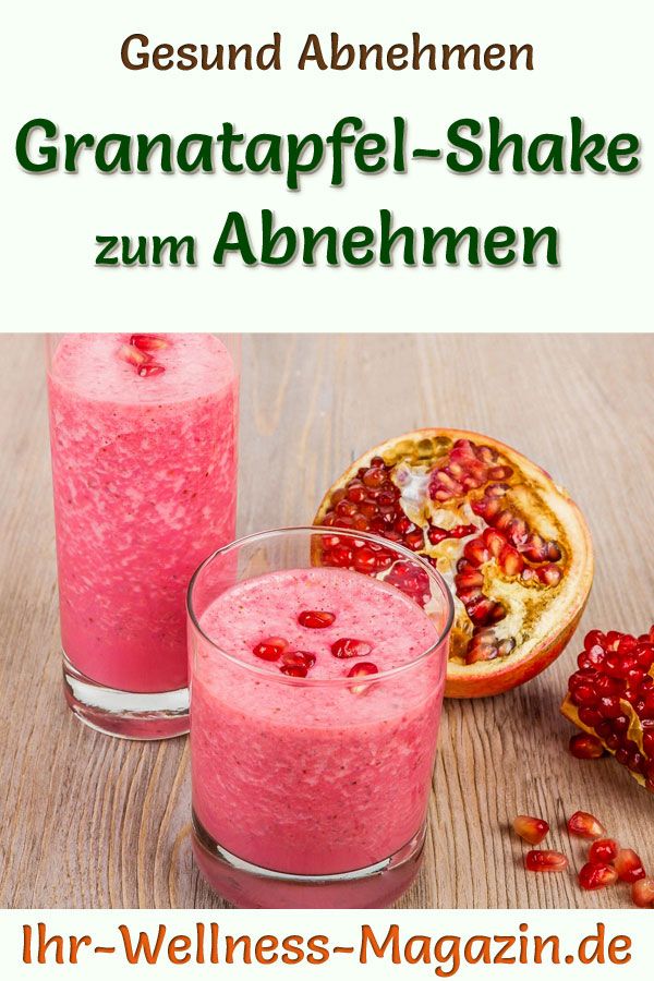 two glasses filled with pink smoothie next to pomegranate