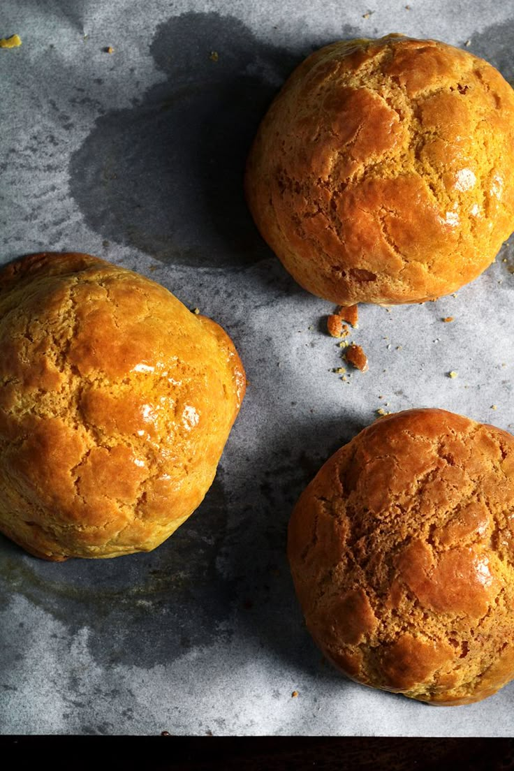 three muffins sitting on top of a table next to each other