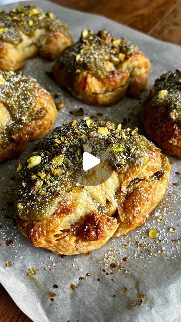 several pastries are sitting on top of a piece of wax paper with sprinkles