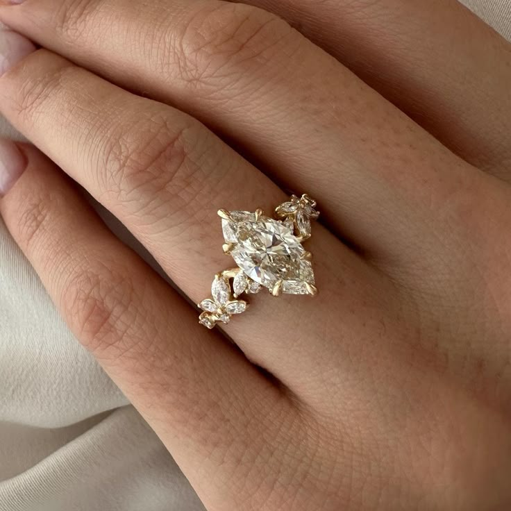 a woman's hand with a diamond ring on it