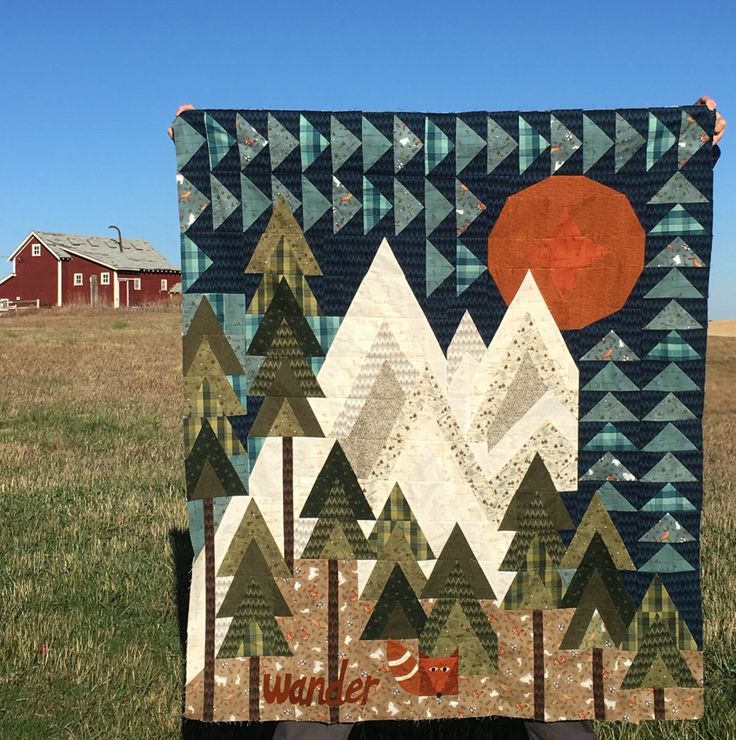 a quilted wall hanging in the middle of a field