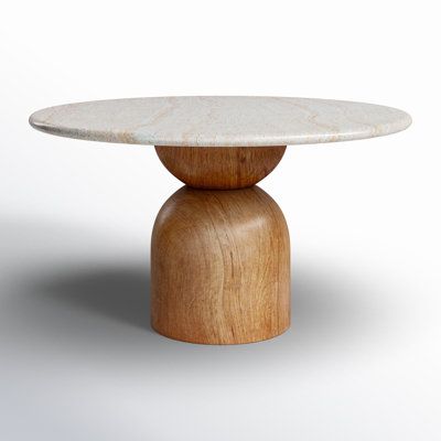 a white marble topped wooden table on a grey background with an oval base and round top