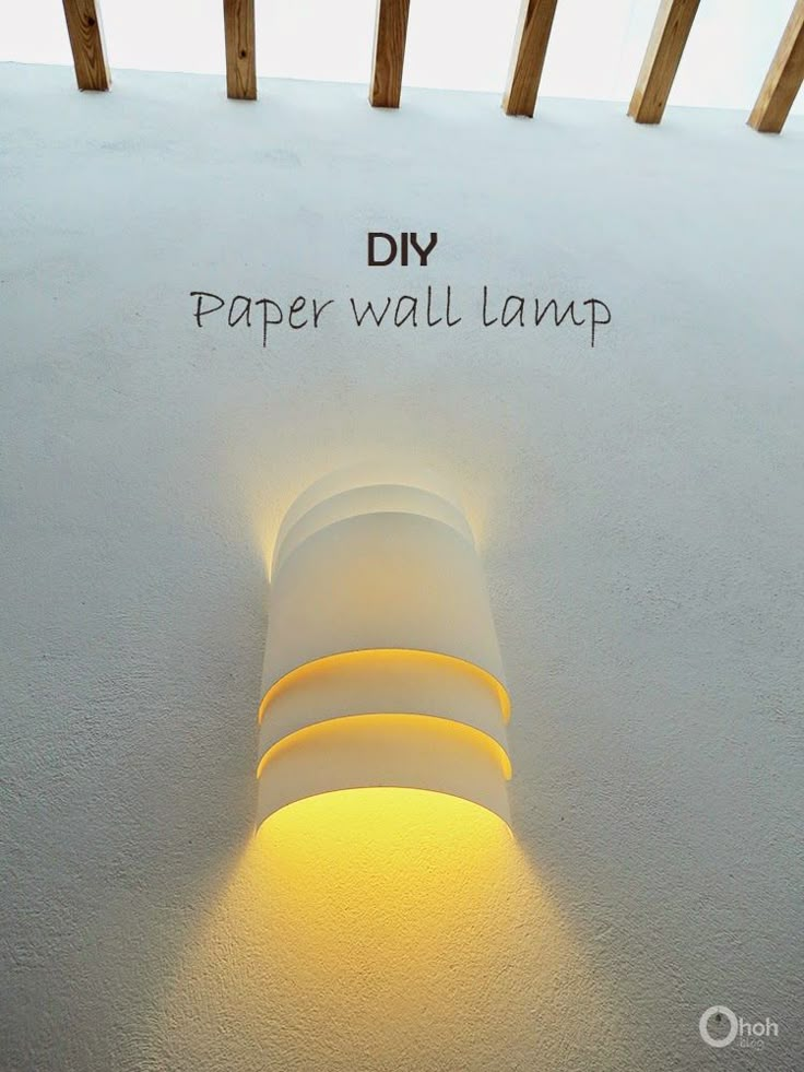 a white wall lamp with the words diy paper wall lamp on it's side