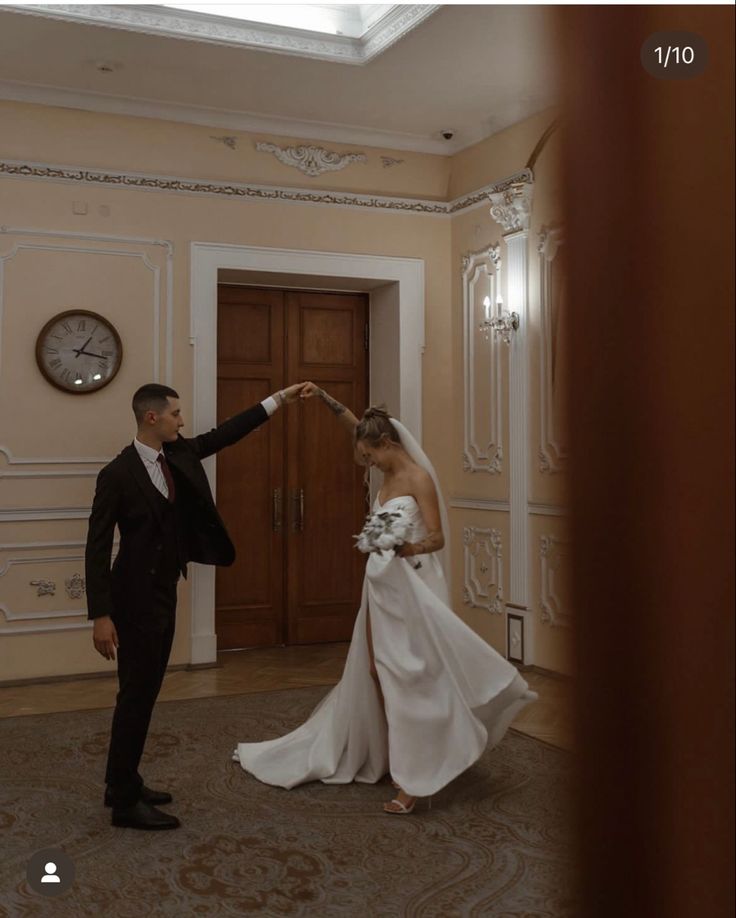 the bride and groom are dancing together in the room