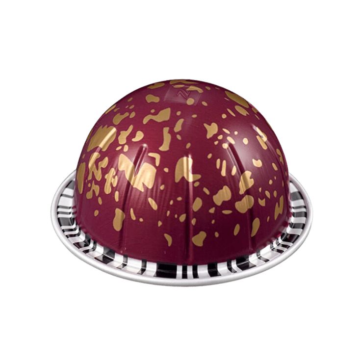 a red and gold helmet is sitting on top of a metal stand with holes in it