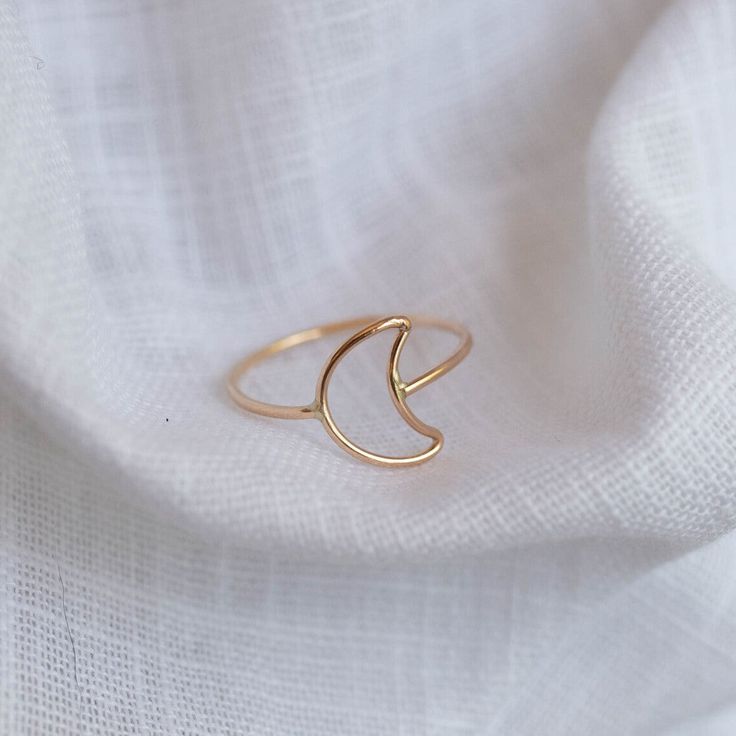 Selene, featuring the crescent moon shaped into a ring and wrapped around your finger. - Made with 14k gold filled or sterling silver material - 1mm round band, 9x12mm crescent moon You may experience a slight color difference in places where the metal has been soldered making every piece truly unique. If you do not see your size, please reach out to us by email at info@hellorising.com. We believe that everyone deserves to wear beautiful jewelry. Purchase three or more rings and save 15% with di Moon Minimalist, Crescent Moon Ring, Tiny Rings, Gold Ring Designs, Moon Ring, Gold Moon, Gold Ring Stack, Moon Shapes, Minimalist Rings