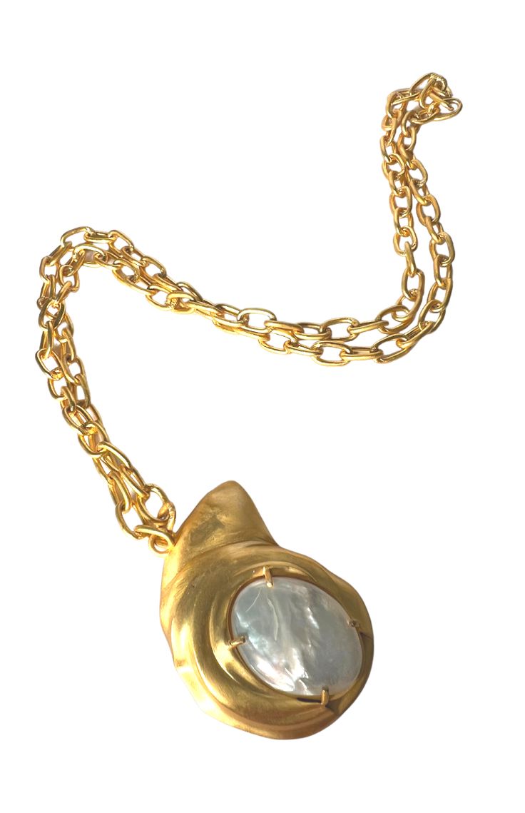 a gold necklace with a white stone in the center and a chain attached to it