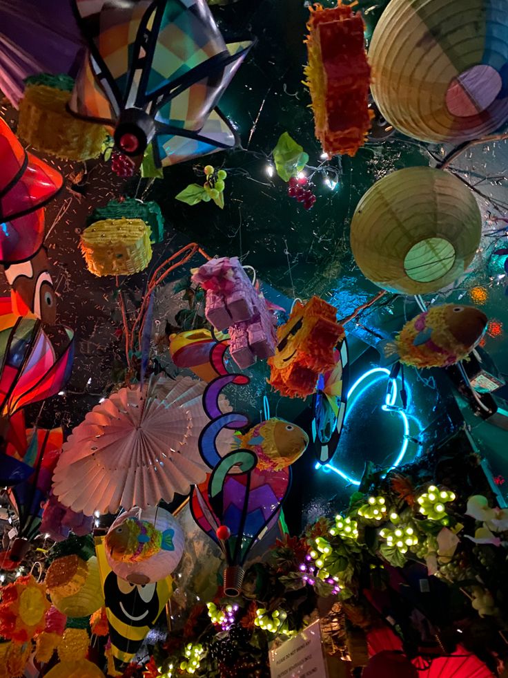 many colorful paper lanterns hanging from the ceiling