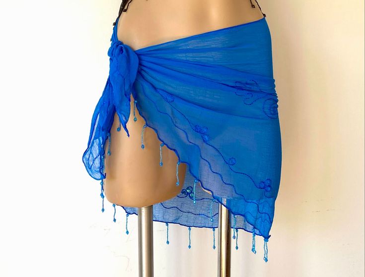 Fantastic little coverup  lives in your bag & takes you from beach to bar as a skirt, a top or both.  Beautiful handmade Resort Wear Sheer Chiffon Sarong, design embroidered & with hand sewn matching sequin accents and a gorgeous dangling completely hand beaded fringe.  When wearing a swimsuit just wont get you into the bar or restaurant, this fantastic skirt and top is a wonderful way to be dressed, look hot and still be resort casual. It's a shoulder cover when the sun goes down & the night ch Bohemian Beaded Swimwear For Beach, Blue Beach Skirt, Beach Sarong Outfit, Pool Fits, Beach Coverups, Mini Rock, Sarong Dress, Resort Casual, Sarong Wrap