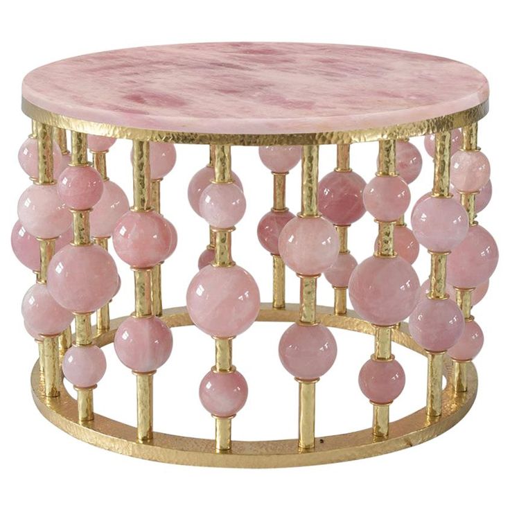 a pink marble table with gold accents