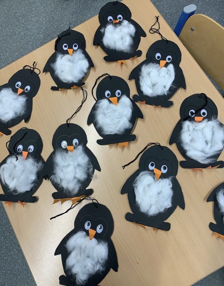 a bunch of penguins that are sitting on a table