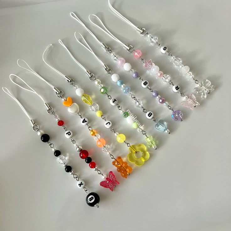 a bunch of different colored beads on a white surface