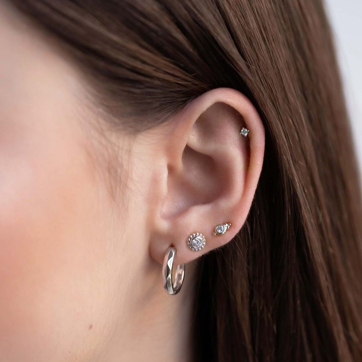 This decorative tiny stud is the perfect add on to your ear stack. Mix and match with our huggies for an on trend look. .925 Sterling Silver Cubic Zirconia Crystal Hypoallergenic post Height 6.2mm x Width 3.1mm Stone center: 2mm #E492 Classic Huggie Internally Threaded Piercings, Classic Internally Threaded Huggie Piercings, Everyday Round Cubic Zirconia Cartilage Earrings, Everyday Round Cubic Zirconia Piercings, Everyday Cubic Zirconia Piercings, Everyday Internally Threaded White Gold Piercings, Hypoallergenic Cubic Zirconia Cartilage Earrings For Anniversary, Hypoallergenic Cubic Zirconia Piercings, Minimalist Cubic Zirconia Piercings For Anniversary