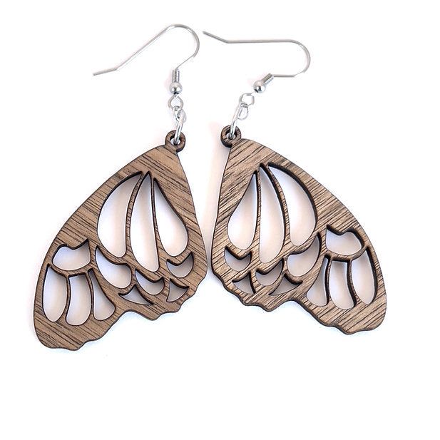 Crafted from premium wood and paired with stainless steel hooks, these earrings feature a captivating butterfly wing design. The intricate cut-out pattern replicates the delicate veins of butterfly wings, making these earrings a perfect choice for nature lovers. Material: Walnut and Stainless Steel Design: Inspired by the delicate beauty of butterfly wings, these earrings showcase a detailed cut-out pattern that captures the essence of a butterfly’s flight. Dimensions: Approx: Dangle: 1" x 2" Hypoallergenic: Yes Butterfly Wing Design, Wings Making, Laser Engraving Ideas, Laser Cut Wood Earrings, Wing Design, Engraving Ideas, Wings Design, Butterfly Wing, Delicate Beauty