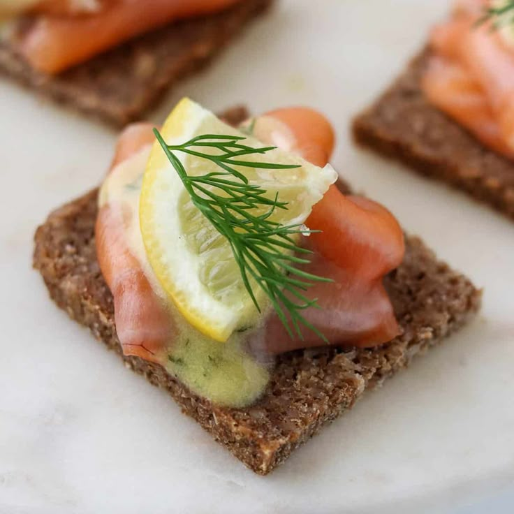 crackers topped with salmon, cucumber and dill