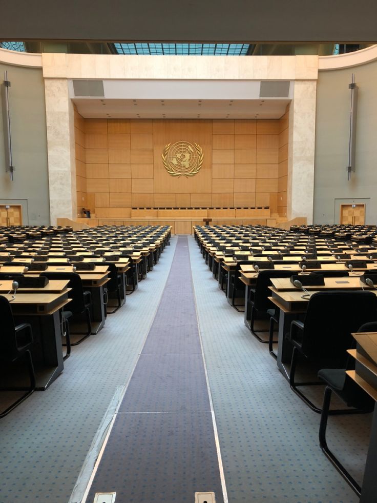 an empty lecture hall with rows of desks