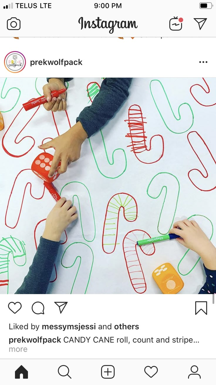 two children using scissors to draw letters and numbers on a sheet of paper with crayons