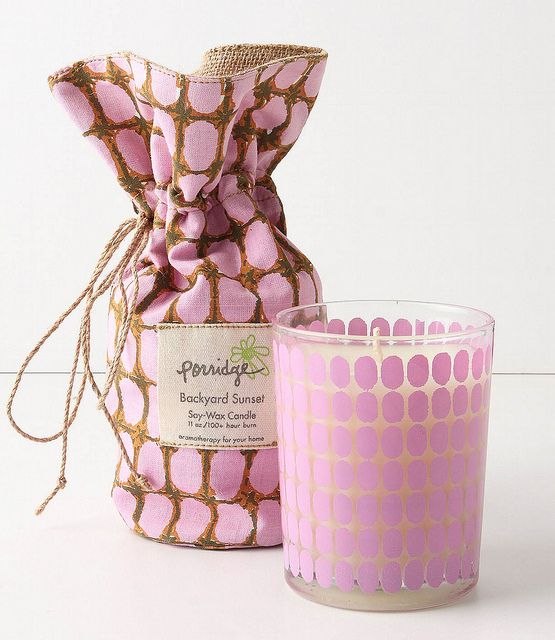 a pink candle sitting next to a bag