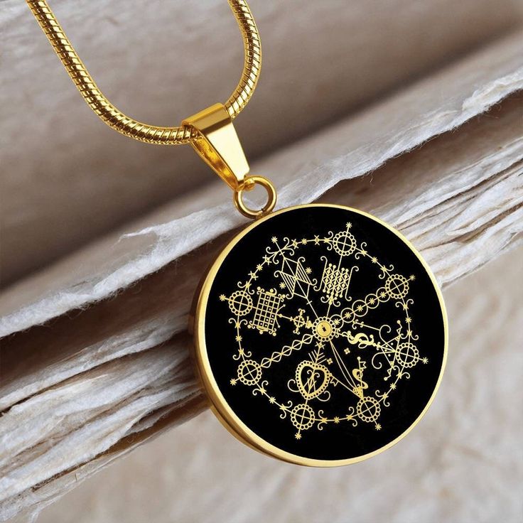 "This MILOKAN Voodoo Veve necklace Is the Perfect Gift! Whether for Yourself or a Loved One.  Explore all our Voodoo Veve jewelry here: https://www.etsy.com/in-en/shop/SymbolicPresent?ref=seller-platform-mcnav§ion_id=22613507 ➜ Our jewelry is made of high-quality surgical steel with a shatterproof liquid glass coating and an 18k gold finish option. ➜ Engrave onto the back of the MILOKAN Voodoo Veve pendant your loved one's name, your wedding date, an anniversary, or anything else you want to rem Round Amulet Necklace With Box Chain, Symbolic Necklace With Round Pendant, Symbolic Necklace With Round Pendant Chain, Symbolic Black Brass Necklace, Black Engraved Brass Necklaces, Symbolic Chain Jewelry As Gift, Voodoo Necklace, Voodoo Veve, Gold Silver Jewelry