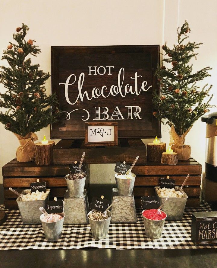 a table topped with lots of desserts next to a sign that says hot chocolate bar