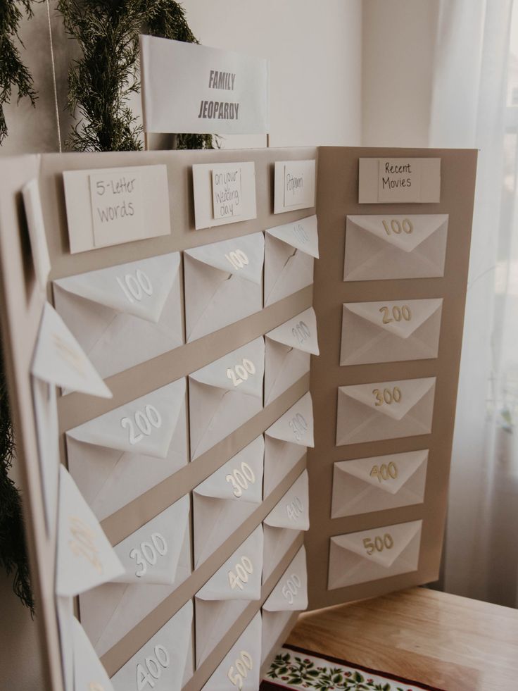 the table is set up with folded paper numbers and place cards on top of it