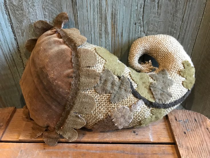 an old stuffed animal sitting on top of a wooden table