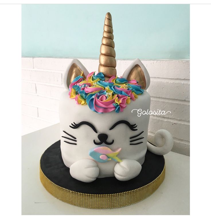 a cake with a unicorn cat on top of it