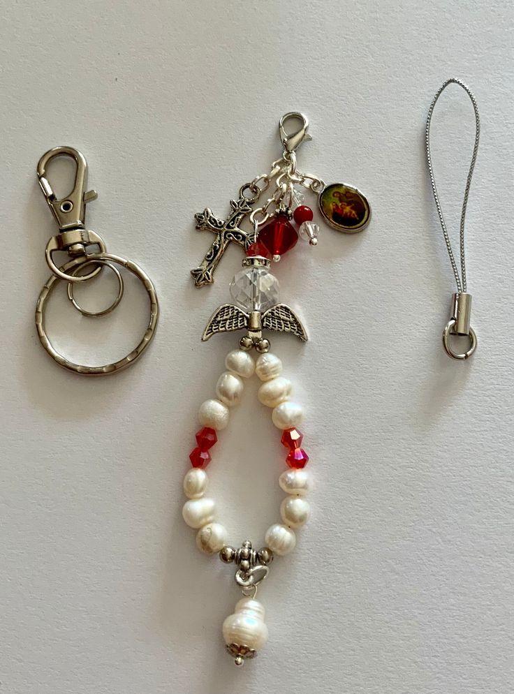 a keychain with charms attached to it on a white surface next to a pair of scissors