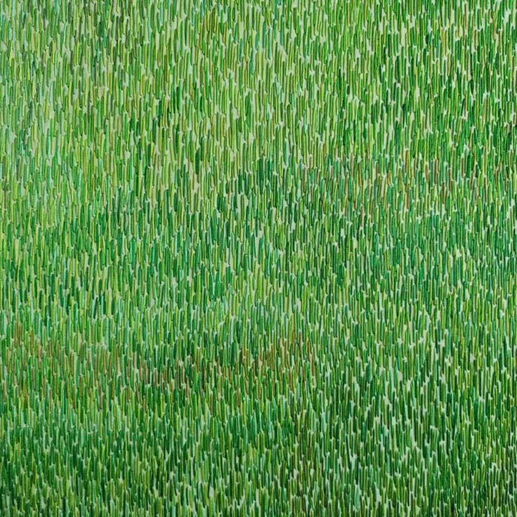 an aerial view of green grass with small white dots