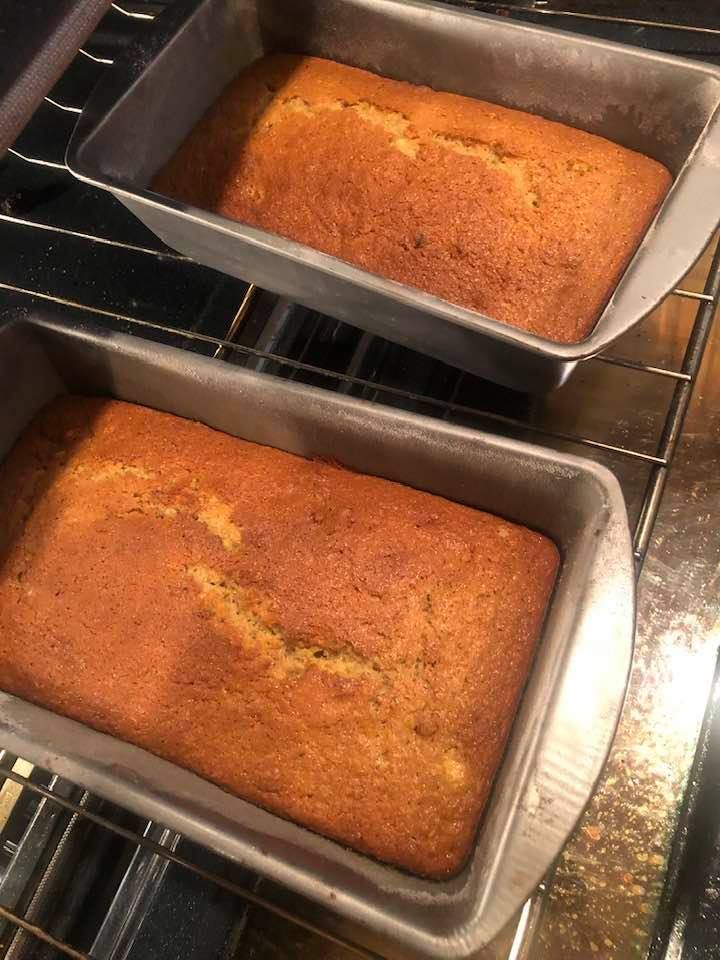 two pans filled with baked goods sitting on top of the oven racks in an oven