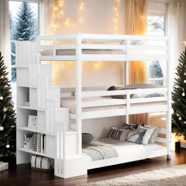 a white bunk bed sitting next to a christmas tree in a room with lights on the windows