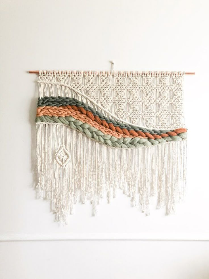 the wall hanging is decorated with multicolored yarn