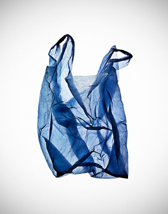 a blue bag is hanging upside down on the ground with it's fabric pulled back