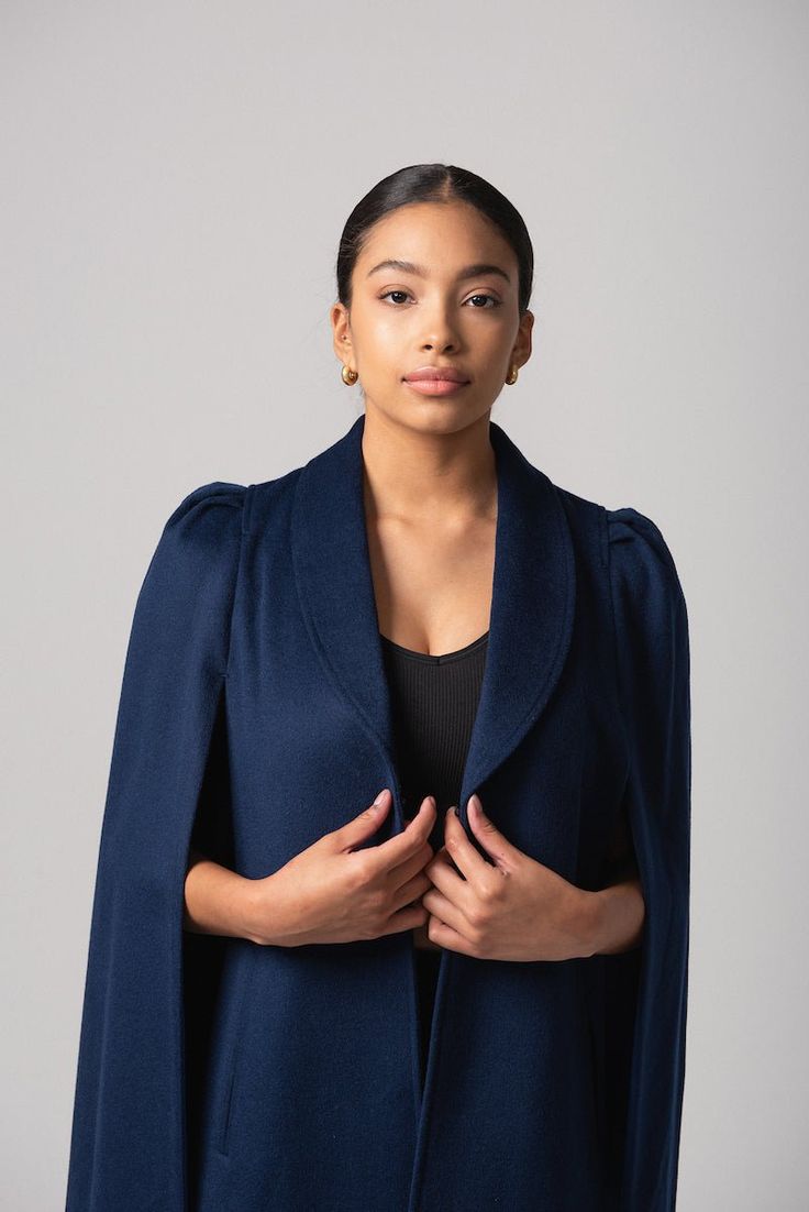 Our latest cape collection is made in a rich wool-cashmere blend, an ideal layering piece for all seasons. The Marina cape has a classic navy hue with a matching blue lining. The unique shoulder detail, a signature NN element in all our capes, creates a bold statement shoulder with the perfect silhouette. Marina is a timeless traditional cape. Add pearls, drape over a striped tee and denim for that classic coastal vibe. However you wear it, it will be uniquely yours and compliments are guarantee