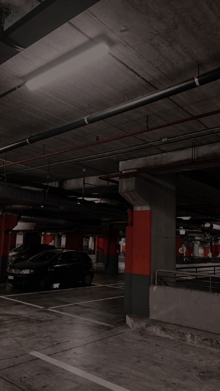 an empty parking garage with cars parked in it