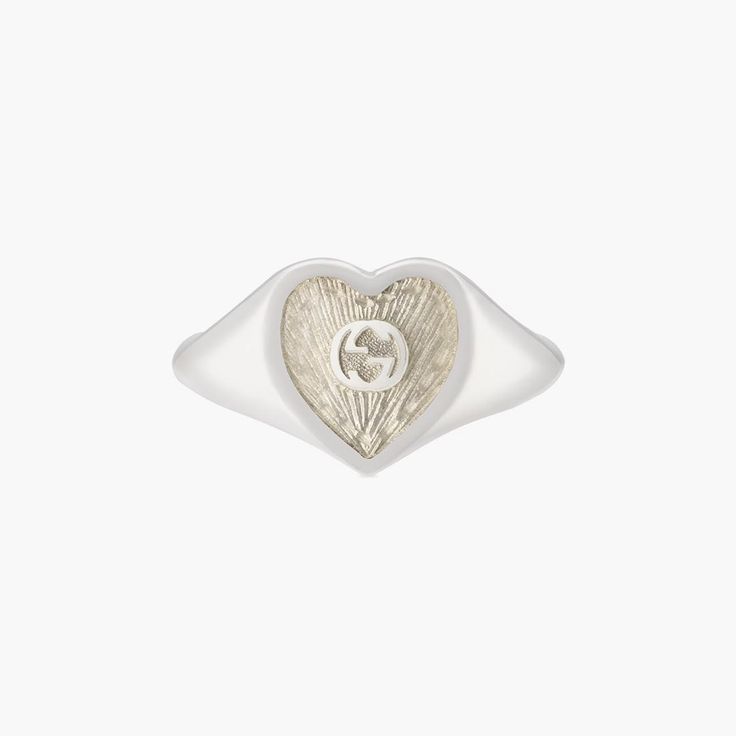 Sterling silver Gucci heart signet ring with white mother-of-pearl enamel. In the center of the Enamel the interlocking G logos is raised. The top of the ring is 0.04" in size. Mother Of Pearl Signet Ring, Engraved White Gold Gucci Jewelry, Gucci Sterling Silver Ring, Classic Gucci Engraved Ring For Anniversary, Classic Gucci Engraved Ring For Gift, Classic Gucci Engraved Ring As Gift, Classic Gucci Engraved White Gold Ring, Gucci White Gold Sterling Silver Ring, Gucci Sterling Silver Ring For Formal Occasions