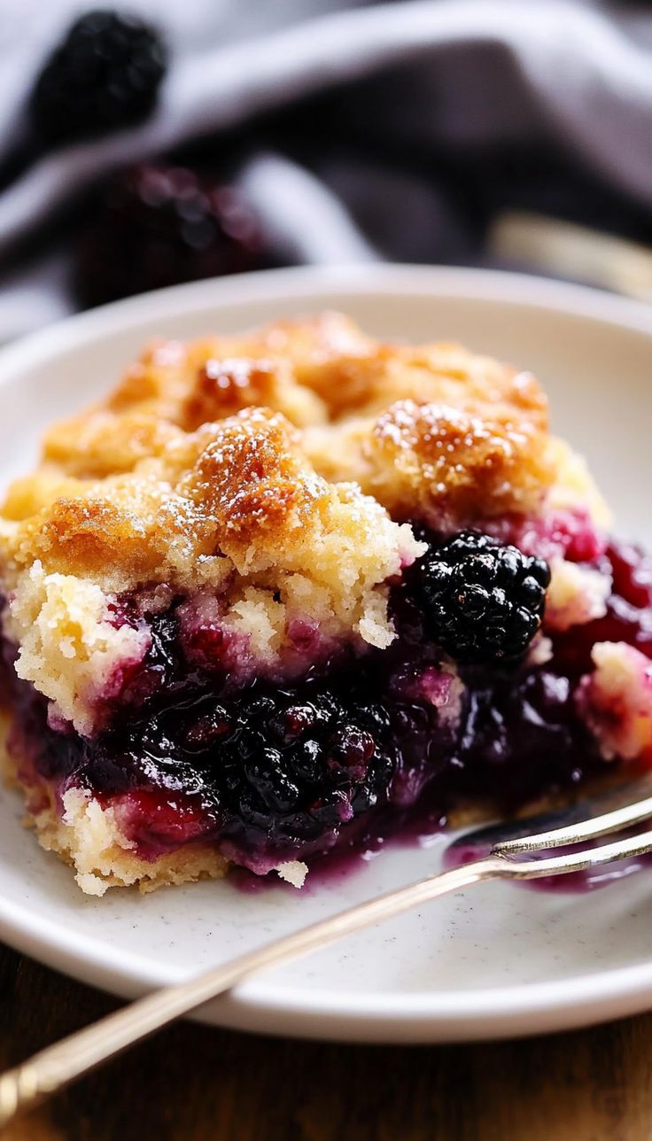 This blackberry cobbler brings together the natural sweetness of fresh blackberries and a golden, buttery crust. With just a few simple ingredients, this dessert is quick to prepare yet delivers an explosion of flavor. The bubbling fruit filling and tender biscuit topping pair beautifully with a scoop of vanilla ice cream or a dollop of whipped cream. Whether served warm or at room temperature, it’s a dessert that captures the essence of homemade goodness. Blackberry Doobie Recipe, Blackberry Baking Recipes, Quick Blackberry Cobbler, Apple Berry Cobbler, Marion Berry Cobbler, Best Cobbler Crust, Cast Iron Blackberry Cobbler, Best Blackberry Cobbler Recipe, Pioneer Woman Blackberry Cobbler