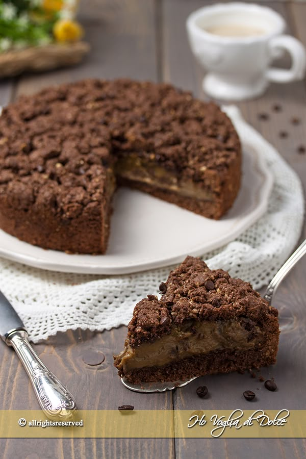 a piece of cake on a white plate with a fork and knife next to it