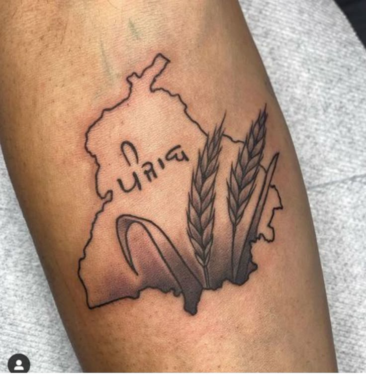 a tattoo on the arm of a man with two ears of wheat