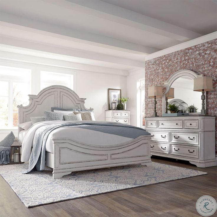 a white bed sitting in a bedroom next to a dresser and mirror on top of a hard wood floor