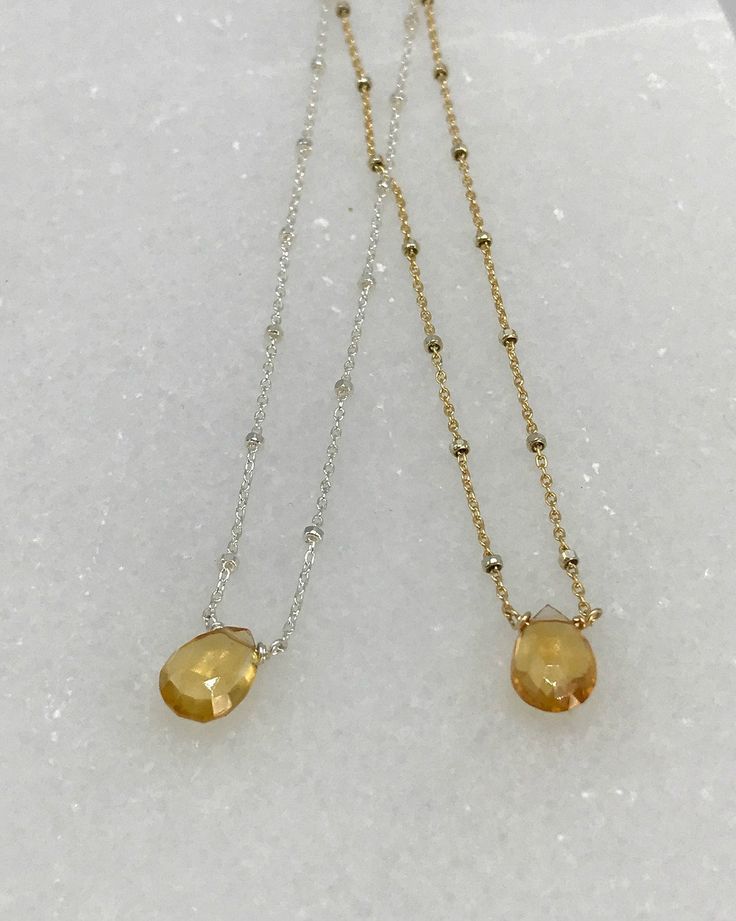 "Step up your everyday jewelry with a golden Citrine Pendant necklace. The faceted tawny sunset Citrine catches the light with every move and looks great with dressy or casual outfits. We have hand wrapped each stone in either 14K Gold-Filled, Sterling Silver or Oxidized Sterling Silver before adding it to the Satellite Chain in coordinating materials. The chain is finished with delicate Citrine Roundels at the closure and end of the two inch extension. This necklace is lovely as a stand-alone p Briolette Faceted Beads Crystal Necklace Gift, Gold Faceted Jewelry For Everyday, Gold Birthstone Crystal Necklace With Teardrop Pendant, Gold Teardrop Pendant Birthstone Crystal Necklace, Gold Teardrop Pendant Crystal Necklace With Birthstone, Gift Teardrop Faceted Bead Crystal Necklace, Everyday Amber Jewelry Birthstone, Everyday Amber Birthstone Jewelry, Elegant Everyday Orange Jewelry