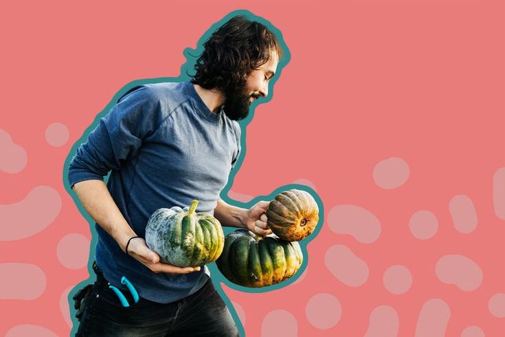 a man holding two gourds in front of a pink and blue background with dots