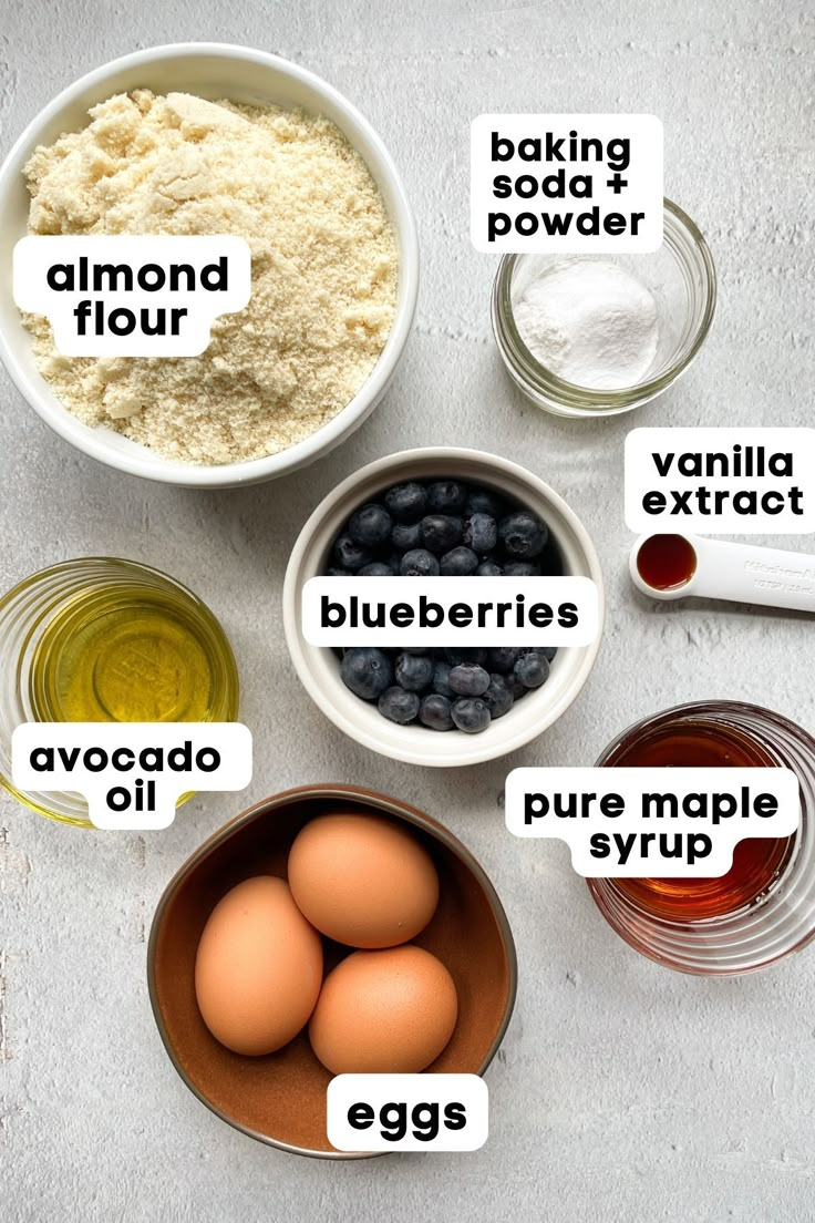 ingredients to make blueberry muffins laid out in bowls