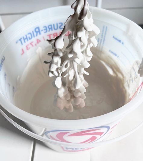 a white bowl filled with liquid on top of a counter