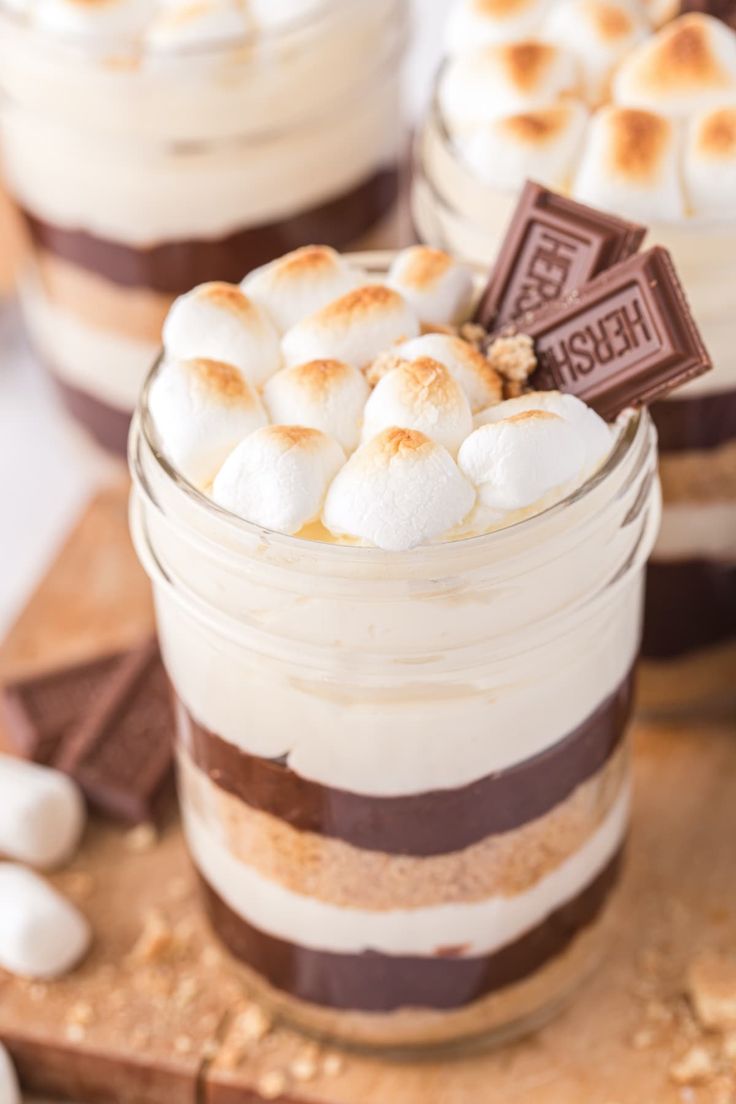 two desserts in jars with marshmallows on top